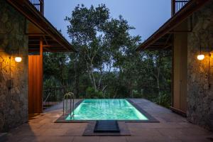 a swimming pool in the backyard of a house at CardMem Hills View Pool Villa & Resort, Thekkady in Thekkady