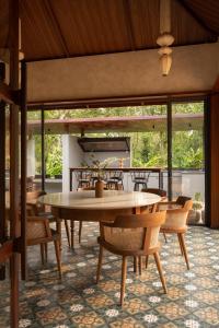 a dining room with a table and chairs at CardMem Hills View Pool Villa & Resort, Thekkady in Thekkady