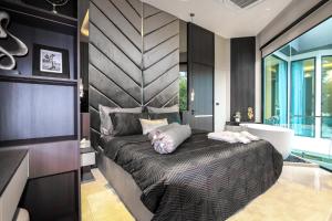 a bedroom with a large bed and a sink at Indiluxe pool villa in Pattaya South +56 photos