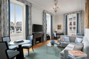 a living room with a couch and a tv at The St. Regis Rome in Rome
