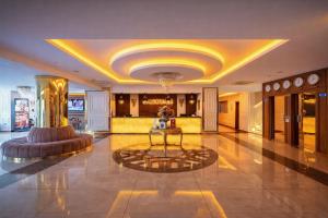 a lobby with a table in the middle of a building at Emirtimes Hotel&Spa - Tuzla in Istanbul +61 photos