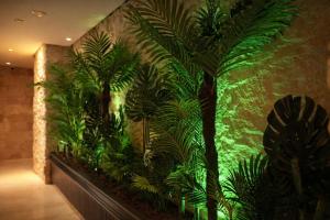 an indoor aquarium with plants on a wall at Emirtimes Hotel&Spa - Tuzla in Istanbul