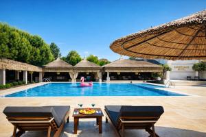 a pool at a resort with a pink flamingo at Emirtimes Hotel&Spa - Tuzla in Istanbul