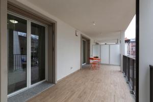 an empty balcony with a table and chairs on a building at Nolo Town Luxury Place in Milan