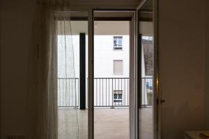 a sliding glass door with a view of a building at Nolo Town Luxury Place in Milan