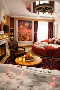a living room with a bed and a bath tub at Emirtimes Hotel&Spa - Tuzla in Istanbul