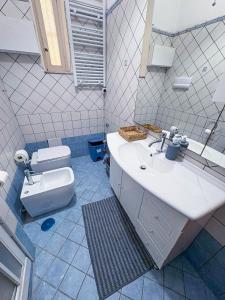 a bathroom with a sink and a toilet at Milion's House Apartments in Salerno +24 photos