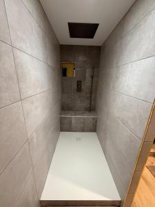 a walk in shower with a white bench in a room at Serenity's Home in Naintré +64 photos