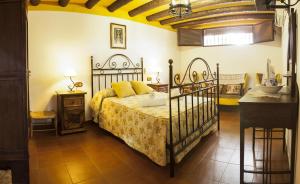 a bedroom with a bed with yellow pillows on it at Cortijo La Algallumbilla in Carcabuey +80 photos