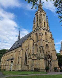 an old church with a tower on top of it at Sudhaus/Alte Brauerei in Meisenheim +1 photo