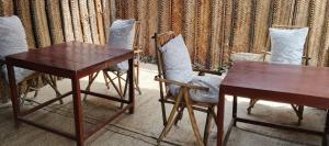 a table and two chairs and a table and a desk at Zamani Matemwe House in Matemwe