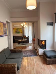 a living room with a couch and a fireplace at Urban art House in Eleusis