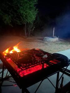 a grill with a fire on top of it at Desert Bloom Cottage in Buffelskloof
