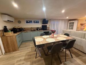a kitchen and living room with a table and chairs at Serenity's Home in Naintré