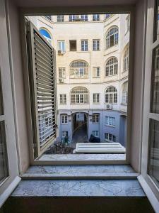 an open window with a view of a building at Milion's House Apartments in Salerno