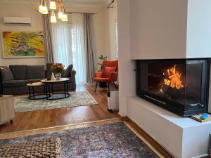 a living room with a fireplace and a couch at Urban art House in Eleusis +4 photos