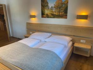 a bedroom with two beds and a painting on the wall at Ferienwohnung Steinacherhof in Arriach