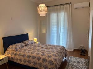a bedroom with a bed in front of a window at Urban art House in Eleusis