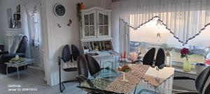 a dining room with a glass table and chairs at Haus KanaleGrande in Haltern