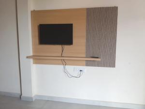 a flat screen tv sitting on a wall at Hotel Awadh Grand in Kānpur
