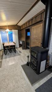 a living room with a fireplace and a pool table at North Frontier Cabins in Saariselka