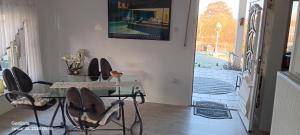 a dining room with a glass table and chairs at Haus KanaleGrande in Haltern +10 photos