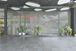 a lobby with potted plants in a building at Sunday Hotel Subang in Subang Jaya