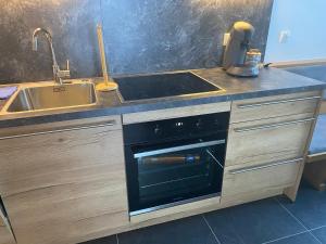 a kitchen with a sink and a stove at Ferienwohnung Steinacherhof in Arriach +73 photos