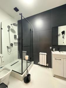 a bathroom with a shower and a toilet and a sink at Avenue Hotel in Almaty +23 photos