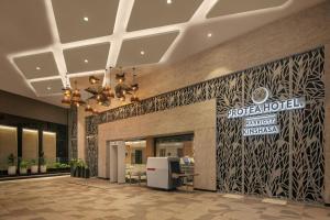 a lobby of a hotel with a sign on the wall at Protea Hotel by Marriott Kinshasa in Kinshasa +49 photos