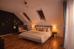a bedroom with a large bed and two lamps at Villa mit Pool und Garten in Thalheim bei Wels +16 photos