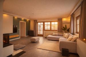 a large living room with a couch and a tv at Villa mit Pool und Garten in Thalheim bei Wels