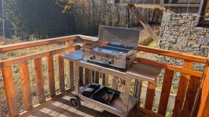 a grill on a table on a wooden deck at Chalet Le Refuge in Vaujany