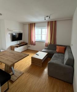 a living room with a couch and a table at Gästezimmer Sengstschmid in Windhaag bei Freistadt