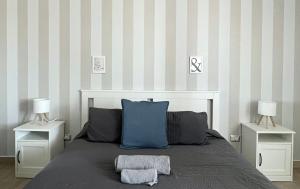 a bedroom with a bed with two night stands and two lamps at Enna Inn Centro in Enna
