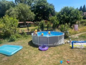 a hot tub with people in it in a yard at Maison du bonheur in Combres