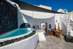 a villa with a swimming pool and a patio at Olia Villas & Suites in Imerovigli