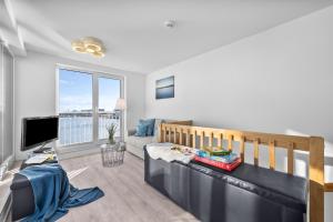 a living room with a crib and a couch at Annas Heimat am Meer in Kappeln