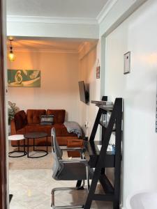 a living room with a couch and a chair at Kj suites in Meru