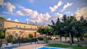 a swimming pool in front of a building at Turisme Rural Mas Ramades in L'Estartit