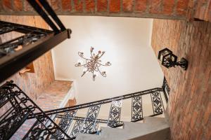an overhead view of a staircase with a chandelier at Casa Balena - The Seafront Whale House Experience in Gansbaai