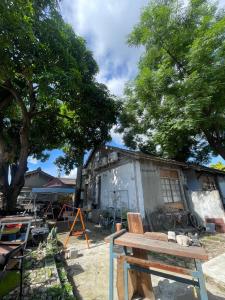 a wooden bench in front of a building at Sunrise Bike Inn 日出單車小棧 in Hsia-ts'ai-yüan