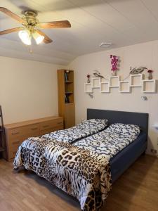 a bedroom with two beds and a ceiling fan at Laufás Guesthouse in Hellissandur +38 photos