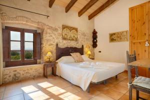 a bedroom with a bed and a window at Turisme Rural Mas Ramades in L'Estartit +50 photos