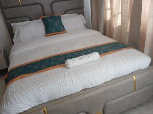 a large bed with two pillows on it at Machakos Town 3 Bedroom Ensuite in Machakos