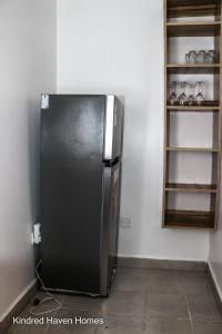 a kitchen with a black refrigerator in a room at Machakos Town 3 Bedroom Ensuite in Machakos