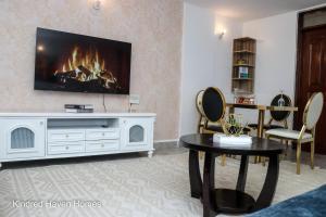 a living room with a tv on a wall at Machakos Town 3 Bedroom Ensuite in Machakos