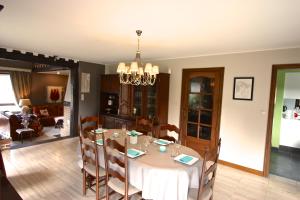 a dining room with a white table and chairs at L'O de La Roche in La Roche-en-Ardenne