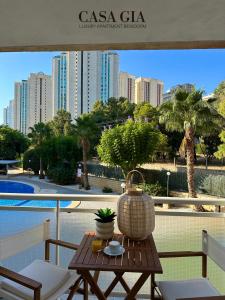 a table on a balcony with a view of a city at CASA GIA l Luxury apartment Benidorm in Benidorm
