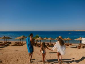 a family walking on the beach at Movenpick Resort Sharm El Sheikh in Sharm El Sheikh